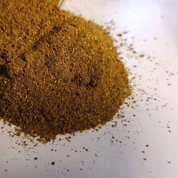 A pile of Habanero Chile Powder on a white surface.