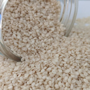 White Certified Organic Sesame seeds in a glass jar.
