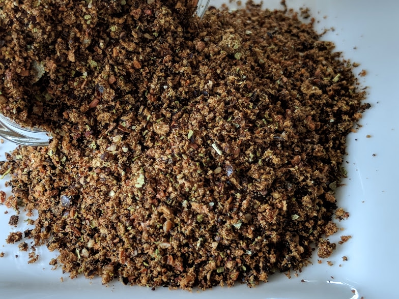 A pile of Moosehead Grilling Rub ~ Certified Organic on a white plate.