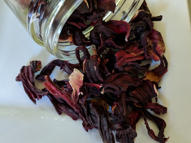 Dried Hibiscus Flower ~ Certified Organic on a white plate.