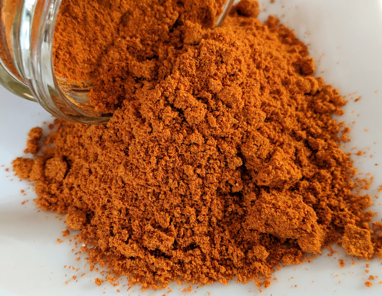 A bowl of Cayenne Chile Powder ~ Certified Organic on a white plate.