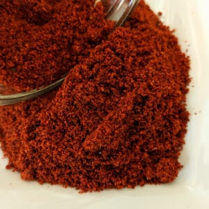 A bowl of Chile Powder, Medium Roast ~ Certified Organic on a white plate.