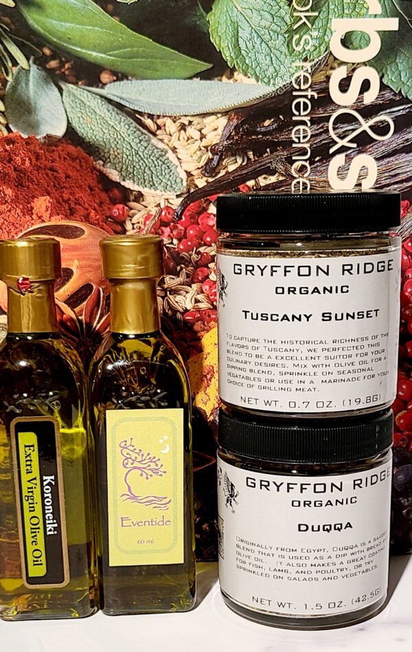 A bottle of Dipping Blends with Olive Oil, a jar of Dipping Blends with Olive Oil, and a jar of spices.