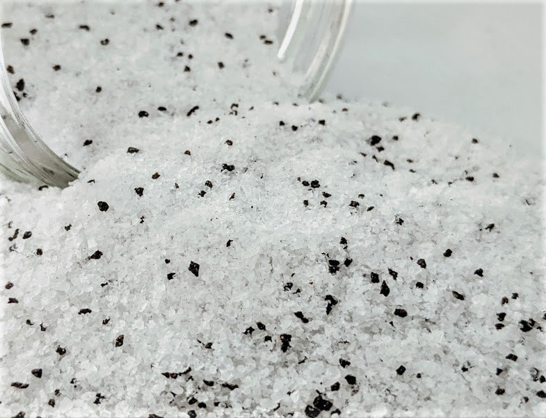 A pile of Black Truffle Salt on a white surface.